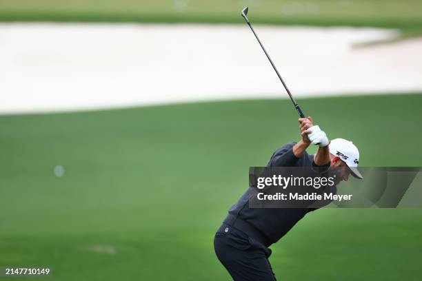 Dustin Johnson of the United States plays a shot in the practice area prior to the 2024 Masters Tournament at Augusta National Golf Club on April 09,...
