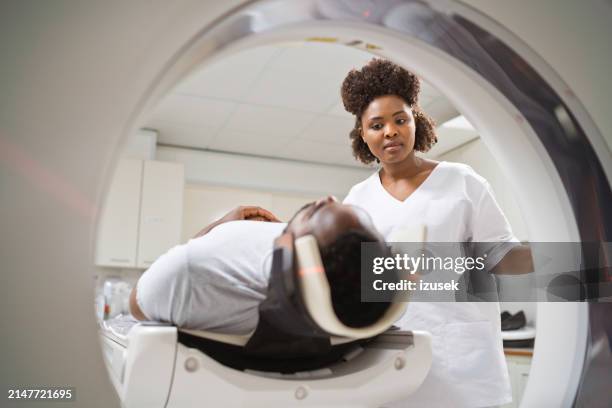 male patient undergoing mri scan in medical examination room - mri scan medische scan stockfoto's en -beelden