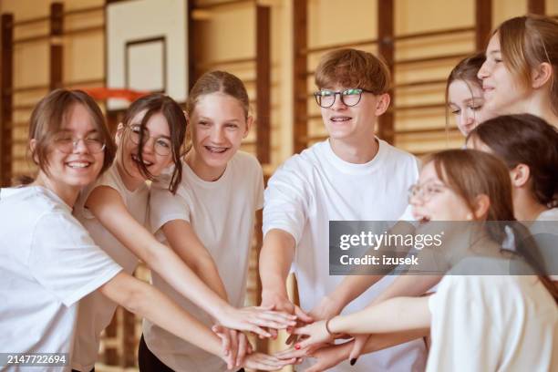 high school students in gym holding hands - gymnastics stock pictures, royalty-free photos & images