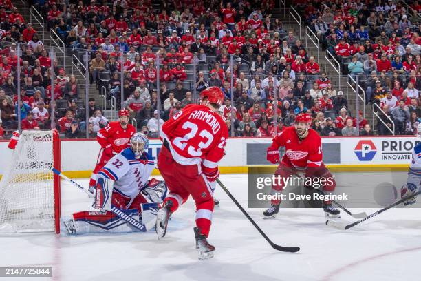 Jonathan Quick of the New York Rangers reacts to a shot next to Robby Fabbri and Lucas Raymond of the Detroit Red Wings during the third period at...