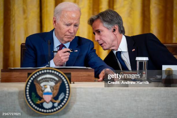 President Joe Biden speaks with Secretary of State Antony Blinken during a trilateral meeting with Japanese Prime Minister Fumio Kishida and Filipino...