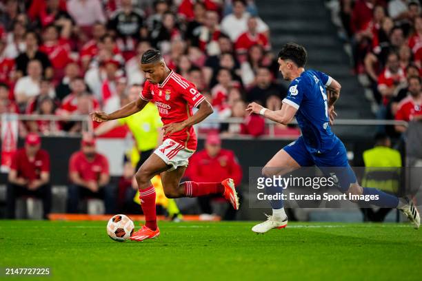 David Neres of Benfica is chased by Leonardo Balerdi of Marseille during the UEFA Europa League 2023/24 Quarter-Final first leg match between SL...