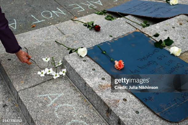 Person flowers on the ground in front of the U.S. Agency for International Development building during a vigil for aid workers killed in the Gaza war...