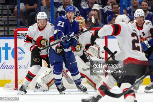 Erik Brannstrom of the Ottawa Senators defends against Brayden Point of the Tampa Bay Lightning during the first period at the Amalie Arena on April...