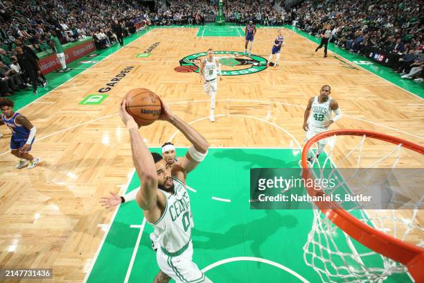 Jayson Tatum of the Boston Celtics dunks the ball during the game against the New York Knicks on April 11, 2024 at the TD Garden in Boston,...