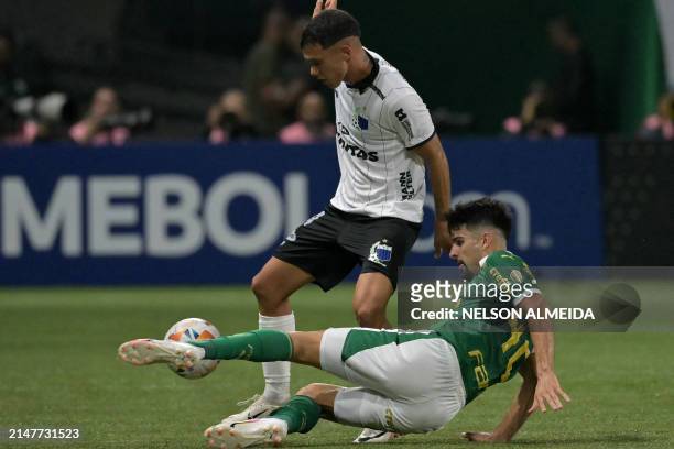 Liverpool's defender Jean Pierre Rosso and Palmeiras' Argentine forward Jose Manuel Lopez fight for the ball during the Copa Libertadores group stage...