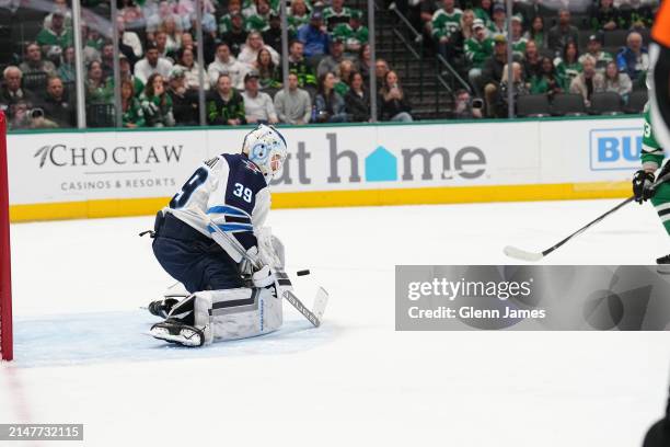 Laurent Brossoit of the Winnipeg Jets makes a save against the Dallas Stars at the American Airlines Center on April 11, 2024 in Dallas, Texas.