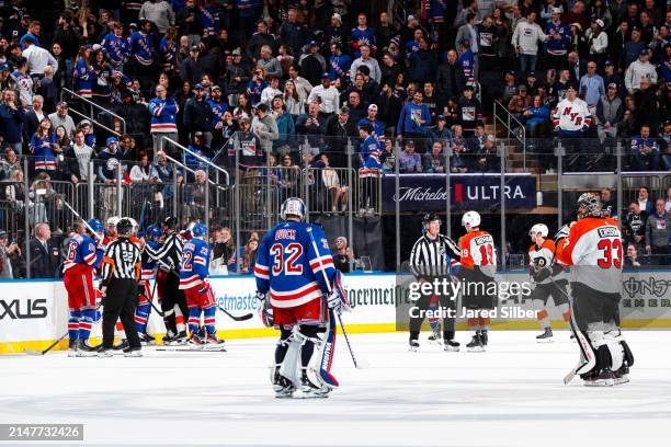 Jonathan Quick of the New York Rangers and Samuel Ersson of the Philadelphia Flyers look on as their teams battle at the end of a period at Madison...