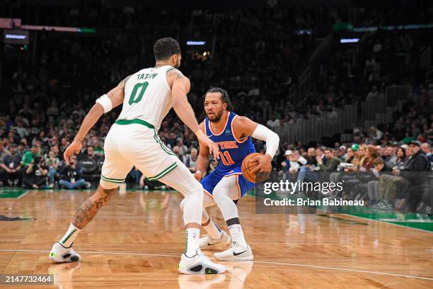 Jayson Tatum of the Boston Celtics plays defense against Jalen Brunson of the New York Knicks during the game on April 11, 2024 at the TD Garden in...