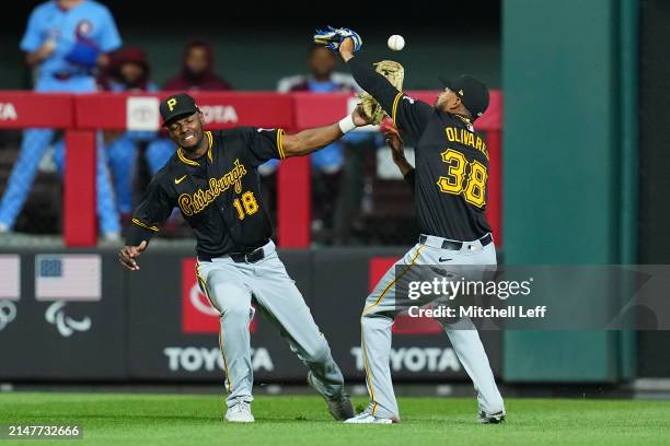 Michael A. Taylor and Edward Olivares of the Pittsburgh Pirates collide and drop a ball off the bat of Nick Castellanos of the Philadelphia Phillies...