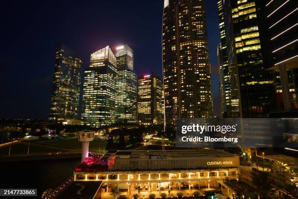 Commercial buildings in the central business district at night in Singapore, on Thursday, April 11, 2024. Singapore's central bank kept its monetary...