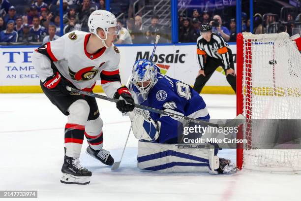 Brady Tkachuk of the Ottawa Senators scores past Matt Tomkins of the Tampa Bay Lightning in the shootout at the Amalie Arena on April 11, 2024 in...