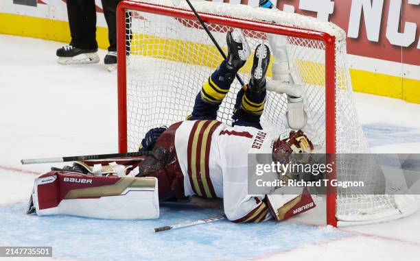 Garrett Schifsky of the Michigan Wolverines crashes into Jacob Fowler of the Boston College Eagles in the third period during the NCAA Men's Hockey...