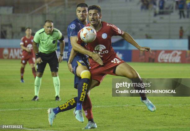 Delfin's Argentine midfielder Cristian Garcia and Belgrano's Chilean midfielder Matias Marin fight for the ball during the Copa Sudamericana group...