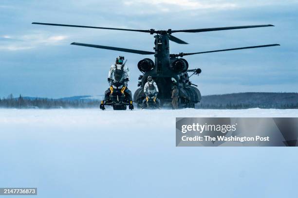 Army Special Forces and Danish special operators from the Jaeger Corps learn how to load and unload snowmobiles onto a CH-47G Chinook at the Yukon...