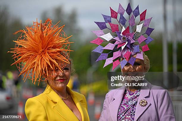 Racegoers pose for a photograph as they attend on Ladies Day, the second day of the Grand National Festival horse race meeting at Aintree Racecourse...