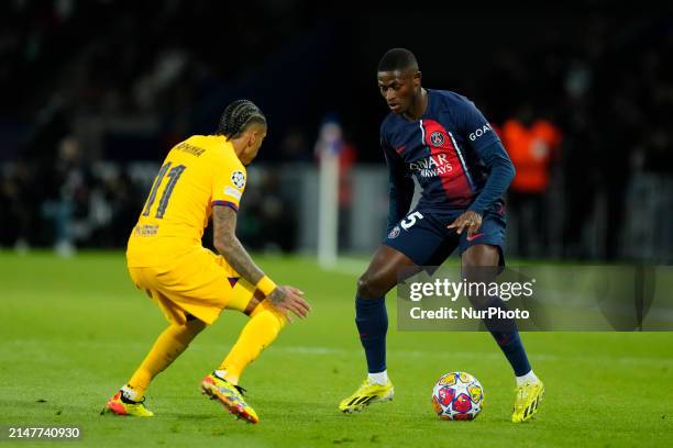 Nuno Mendes left-back of PSG and Portugal and Raphinha right winger of Barcelona and Brazil compete for the ball during the UEFA Champions League...
