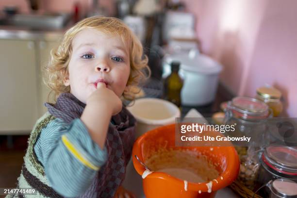 In this photo illustration a toddler is tasting cake batter on December 28, 2023 in Bonn, Germany.