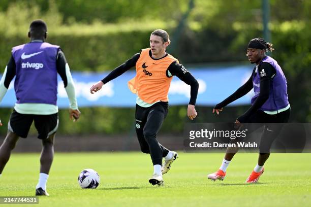 Conor Gallagher and Noni Madueke of Chelsea during a training session at Chelsea Training Ground on April 12, 2024 in Cobham, England.