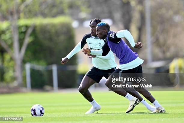 Trevoh Chalobah and Nicolas Jackson of Chelsea during a training session at Chelsea Training Ground on April 12, 2024 in Cobham, England.