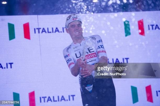 Pavel Sivakov of Russia and UAE Team Emirates celebrating with champagne on podium after the 2024 Giro d'Abruzzo in L'Aquila, Italy, on April 12th,...