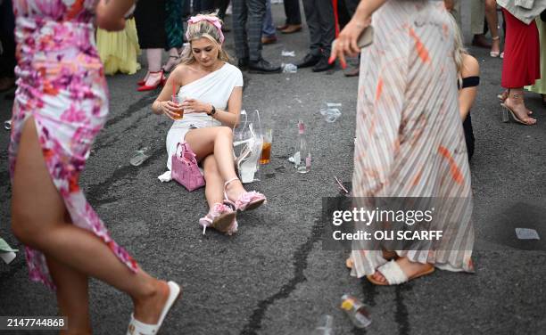 Racegoers attend the second day of the Grand National Festival horse race meeting at Aintree Racecourse in Liverpool, north-west England, on April...