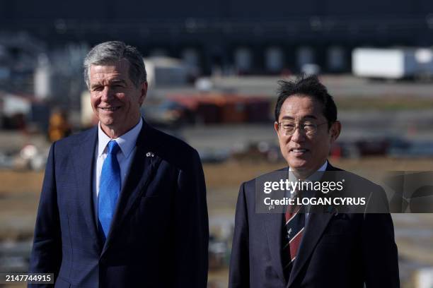 Japanese Prime Minister Fumio Kishida , poses with North Carolina Governor Roy Cooper during a tour of the new Toyota battery factory in Liberty,...