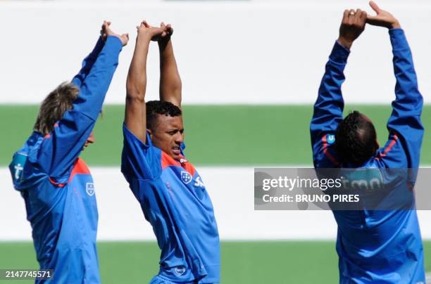 Portugal's Fabio Coentrao , "Nani" Cunha e Liedson Muniz strech during the team's training session at Santos Pinto Stadium in Covilha, central...