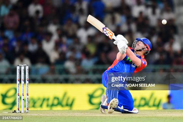 Delhi Capitals' David Warner plays a shot during the Indian Premier League Twenty20 cricket match between Lucknow Super Giants and Delhi Capitals at...