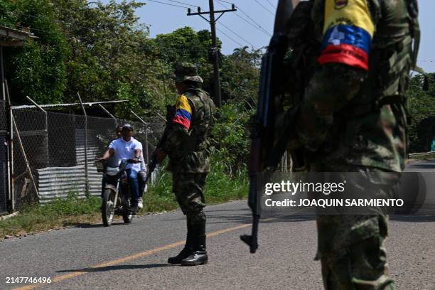 Guerrilla dissidents from the Dagoberto Ramos front stand guard at a check point on a road near Corinto, Cauca department, Colombia on April 12,...