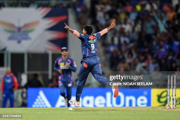 Lucknow Super Giants' Yash Thakur celebrates after taking the wicket of Delhi Capitals' David Warner during the Indian Premier League Twenty20...
