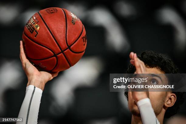Bourg-en-Bresse's French forward Zaccharie Risacher takes part in a warm up session ahead of the Eurocup second leg basketball match between JL Bourg...