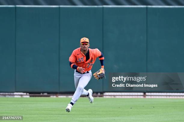 Kenni Gomez of the Houston Astros fields a fly ball during the seventh inning of a spring training Spring Breakout game against the St. Louis...