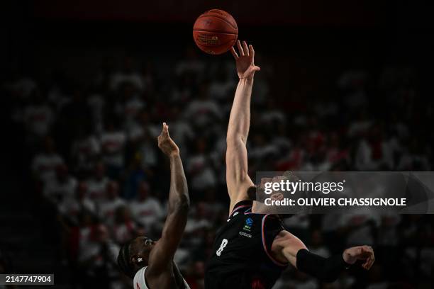 Paris' German centre Leon Kratzer jumps to catch the ball during the Eurocup second leg basketball match between JL Bourg and Paris basketball at the...
