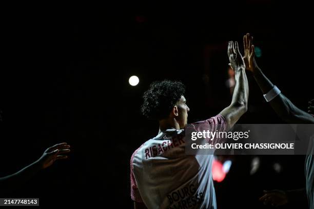 Bourg-en-Bresse's French forward Zaccharie Risacher gives a high five during the Eurocup second leg basketball match between JL Bourg and Paris...
