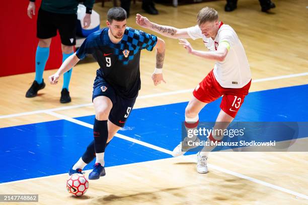 Luka Peric of Croatia and Tomasz Kriezel of Poland battle for the ball during the FIFA World Cup 2024 Play Off match between Poland and Croatia on...
