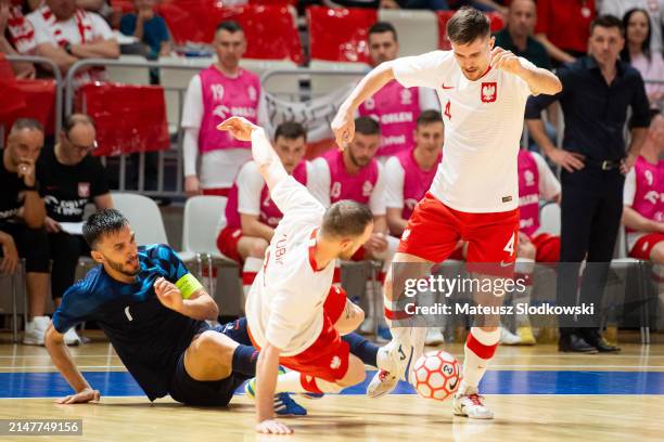 Franko Jelovcic of Croatia, Michal Kubik of Poland and Piotr Skiepko of Poland battle for the ball during the FIFA World Cup 2024 Play Off match...