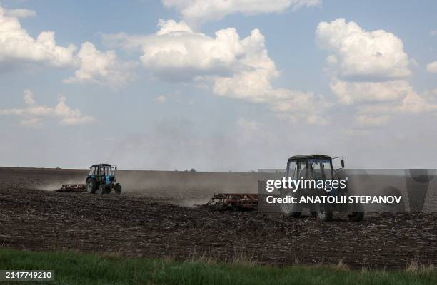 Farmers cultivate a field in the Donetsk region, on April 12 amid the Russian invasion of Ukraine.