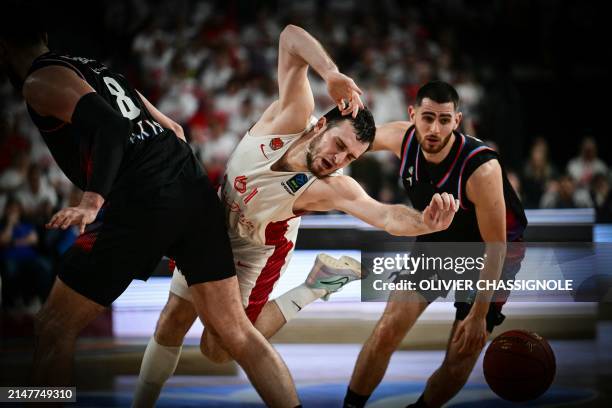 Bourg-en-Bresse's French point guard Axel Julien fights for the ball during the Eurocup second leg basketball match between JL Bourg and Paris...