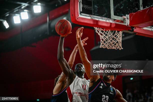 Bourg-en-Bresse's French centre Bodian Massa puts up the ball to the basket during the Eurocup second leg basketball match between JL Bourg and Paris...