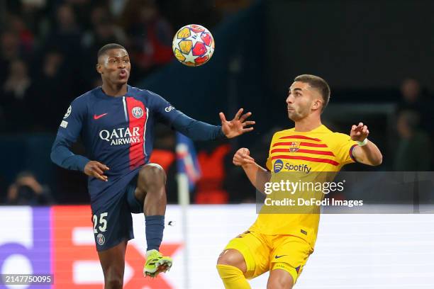 Nuno Mendes of Paris Saint-Germain and Ferran Torres of FC Barcelona battle for the ball during the UEFA Champions League quarter-final first leg...