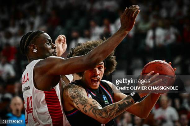 Paris' US forward Tyson Ward is blocked by Bourg-en-Bresse's Canadian forward Isiaha Mike during the Eurocup second leg basketball match between JL...