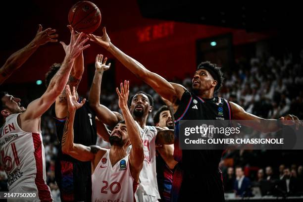 Bourg-en-Bresse's French forward Axel Julien fights for the ball with Paris' US forward Justin Simon during the Eurocup second leg basketball match...