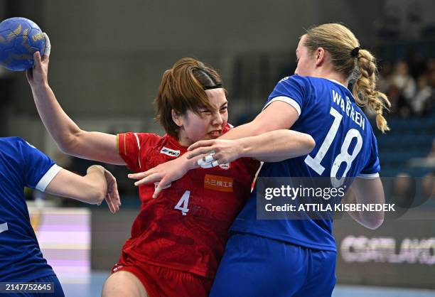 Japan's pivot Miyako Hatsumi attempts to get past Britain's pivot Heidi Jane Warren during the women's Handball Olympic qualifying match between...