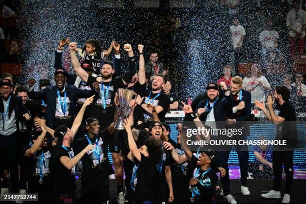 Paris' team celebrates with the trophy on the podium after winning the Eurocup second leg basketball match between JL Bourg and Paris basketball at...