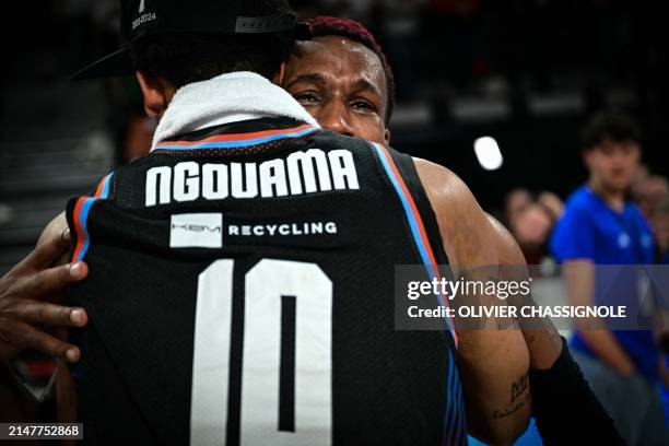 Paris' US point guard Timothy Neocartes TJ Shorts celebrates with Paris' French guard Mehdy Ngouama after winning the Eurocup second leg basketball...