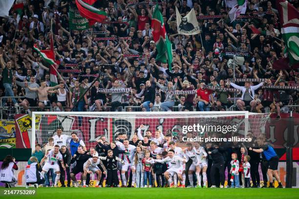 April 2024, Bavaria, Augsburg: Soccer: Bundesliga, FC Augsburg - 1. FC Union Berlin, Matchday 29, WWK-Arena. The FC Augsburg players celebrate their...