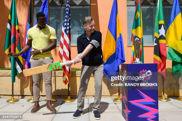 Ambassador to Barbados and the Eastern Caribbean Roger Nyhus gets batting tips from Carlos Brathwaite of West Indies during the trophy tour for the...