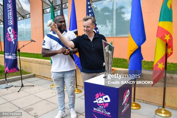 Ambassador to Barbados and the Eastern Caribbean Roger Nyhus gets bowling tips from Ashley Nurse of West Indies during the trophy tour for the ICC...
