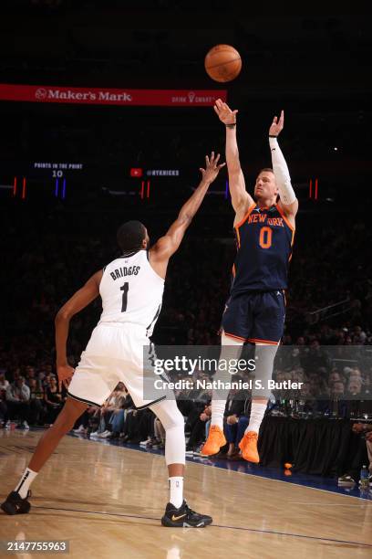 Donte Divincenzo of the New York Knicks shoots a three point basket against the Brooklyn Nets on April 12, 2024 at Madison Square Garden in New York...